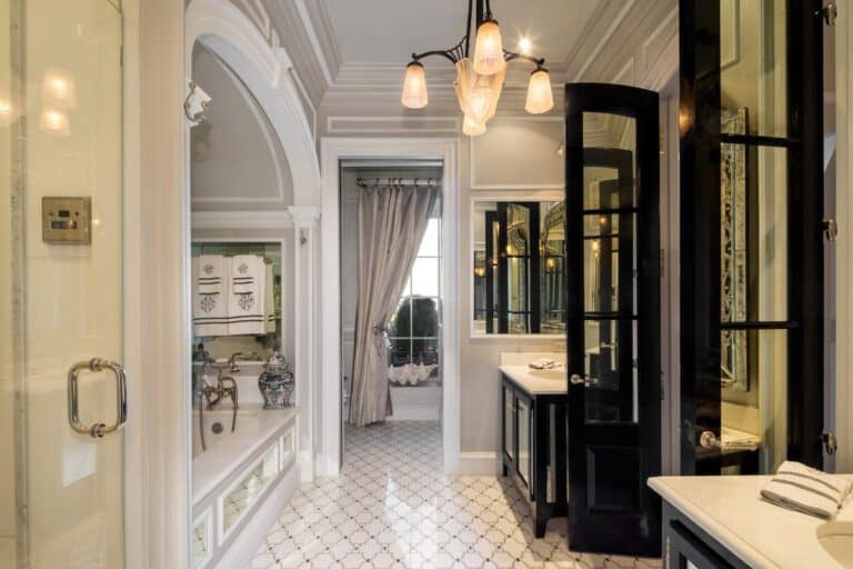 Luxurious bathroom with elegant fixtures, black and white cabinetry, and ornate decor, showcasing high-end residential interior design and custom remodeling.