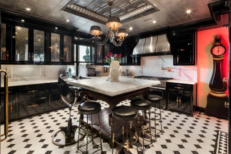 Luxury modern black kitchen with elegant marble countertops and a stylish central island, featuring black bar stools, contemporary lighting, and sophisticated decor, showcasing Iridium Development Inc. craftsmanship.