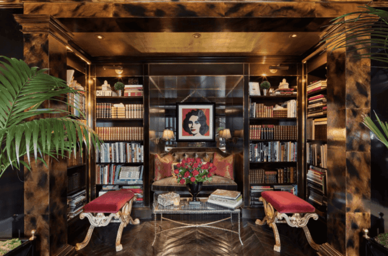 Lavish library with dark wood bookshelves, plush seating, and elegant decor, featuring contemporary art and cozy lighting for a sophisticated reading environment.